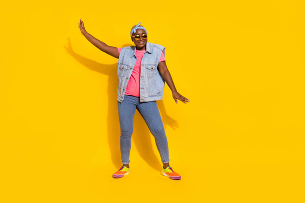 Full size portrait of cheerful excited lady enjoy discotheque dancing isolated on yellow color background. - Valokuva, kuva