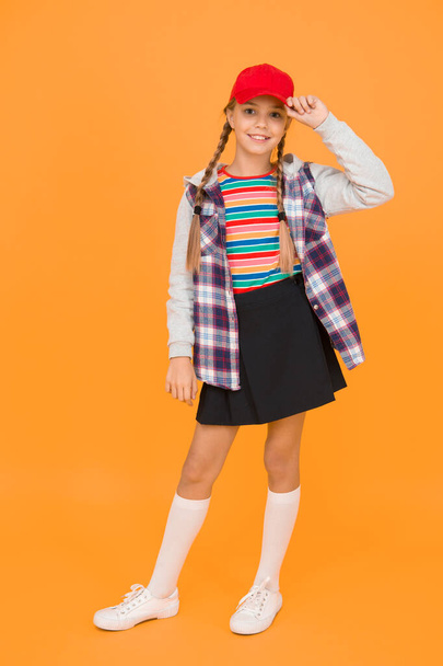 Tomboy concept. Teen age. Girl adorable stylish outfit teenager. Comfortable outfit. Modern outfit. Rebellious teen. Street style. Cool schoolgirl. Have fun charismatic girl on yellow background. - Fotografie, Obrázek