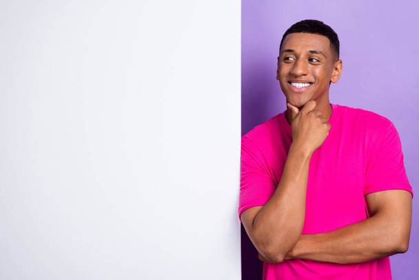Photo of positive minded man wear stylish pink clothes interested look empty space decision solution isolated on purple color background. - Foto, Imagem