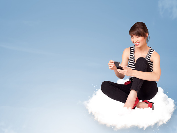 Young woman sitting on cloud with copy space - Zdjęcie, obraz