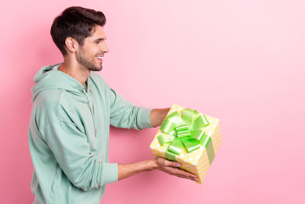 Profile portrait of cheerful person hands hold give giftbox empty space isolated on pink color background. - Foto, Bild