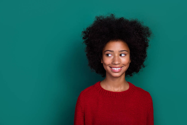 Photo of positive adorable person beaming smile look interested empty space isolated on green color background. - Zdjęcie, obraz