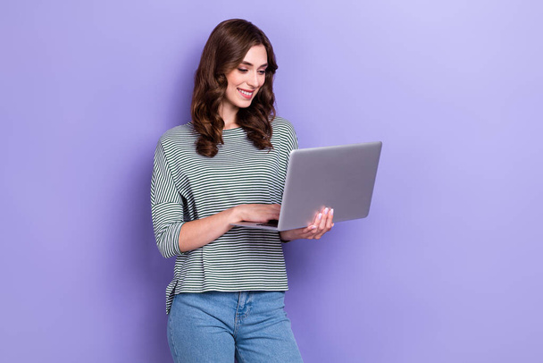 Photo of concentrated pretty lady wear trendy clothes use gadget netbook write friends read news isolated on purple color background. - Photo, Image