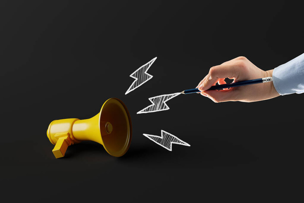 Yellow megaphone making hand-drawn sounds. Concept of communication, information transfer. - Zdjęcie, obraz