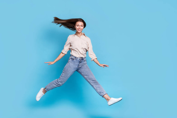 Full length photo of lady run wear shirt jeans shoes isolated on blue color background. - Fotó, kép
