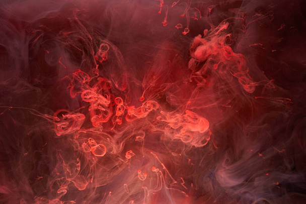 Red ink abstract background. Acrylic paint backdrop for perfume, hookah, cosmetics. Mysterious smoke clouds, colorful fog - Foto, Imagem