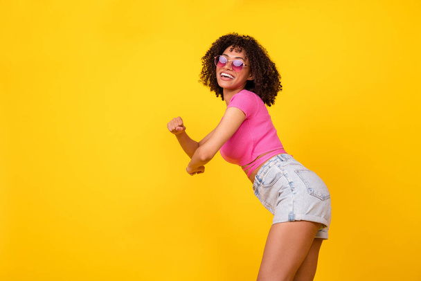 Profile photo of positive pretty lady enjoy clubbing partying dance make moves isolated on yellow color background. - Fotó, kép