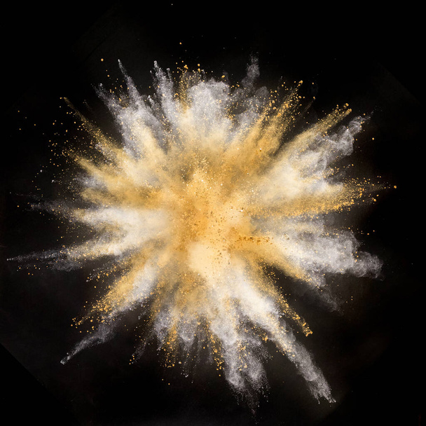 Freeze motion shot of color powder explosion isolated on black background - Photo, Image