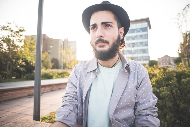 Hipster bearded man in hat in town - Photo, Image