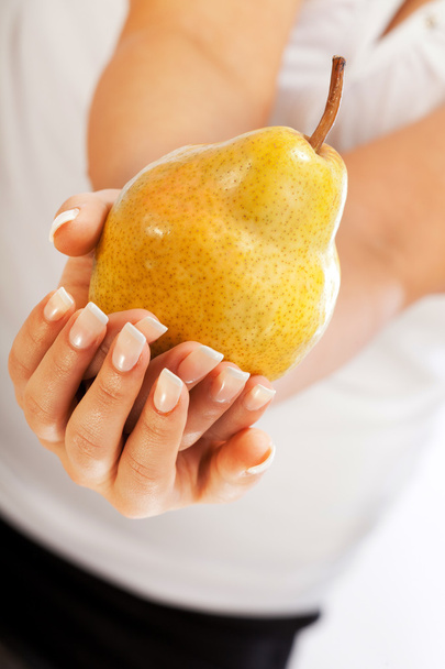Young woman holding pear - Foto, Imagem