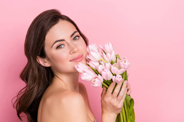 Photo of adorable sweet young woman naked enjoying flowers bloom empty space isolated pink color background. - Foto, Bild