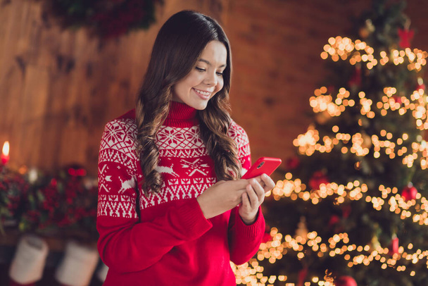 Photo of adorable pretty lady blogger use modern device choose gifts rejoice advent night eve enjoy magic time room house home. - Photo, image