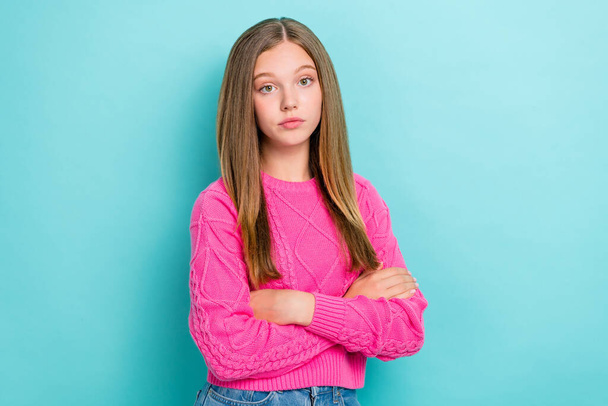 Photo of serious upset bored girl with straight hairstyle wear pink knit sweater arms crossed standing isolated on blue color background. - 写真・画像