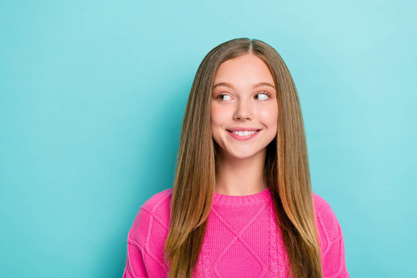 Photo of curious nice cute girl with straight hairstyle dressed pink knit sweater look empty space isolated on blue color background. - Foto, immagini