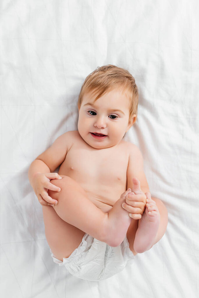 Beautiful smiling cute baby. Close up portrait of happy lying baby looking at camera. - 写真・画像