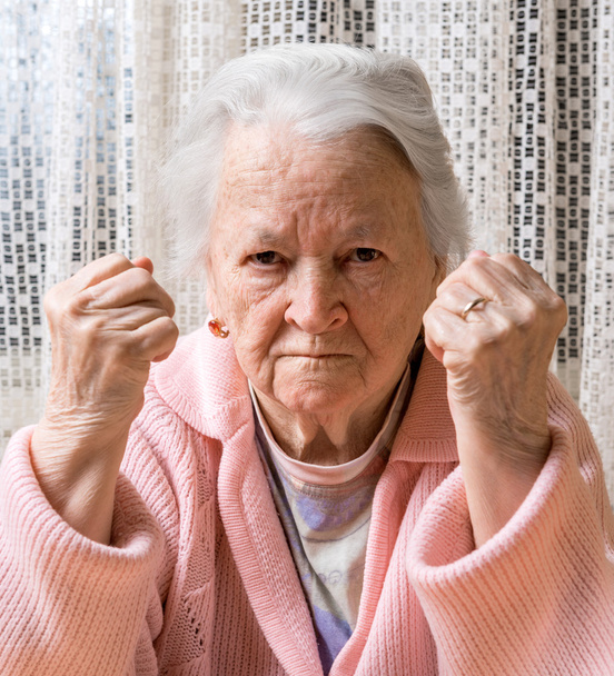 Portrait of  old woman in angry gesture - Photo, Image