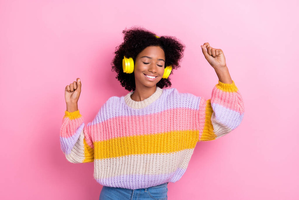 Portrait of positive good mood cute girl with wavy hairdo wear knit sweatshirt headphones dancing isolated on pink color background. - Foto, Imagen