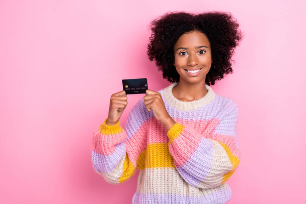 Photo of positive cheerful good mood girl with perming coiffure wear knit sweater holding debit card isolated on pink color background. - Foto, Imagem