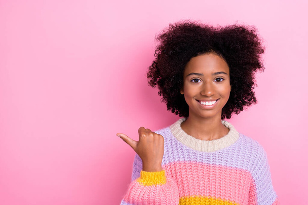 Portrait of good mood adorable girl with wavy hairstyle dressed knit sweatshirt directing empty space isolated on pink color background. - Φωτογραφία, εικόνα