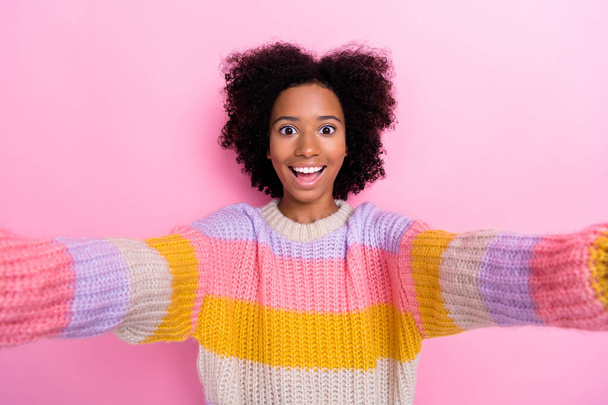 Portrait of impressed exited girl with wavy hairstyle dressed knit sweatshirt doing selfie staring isolated on pink color background. - Foto, Imagem