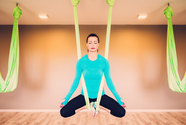 Jovem mulher realizando exercício de ioga antigravidade - Foto, Imagem