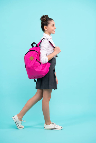 School girl in school uniform with backpack. Teenage girl student on blue isolated background. Learning knowledge and kids education concept. Full length teenager, schoolgirl - Fotoğraf, Görsel