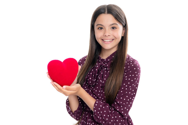 Happiness kids and love concept. Romantic lovely teen girl with red heart, world heart day, happy valentines day. Portrait of happy smiling teenage child girl - Фото, изображение