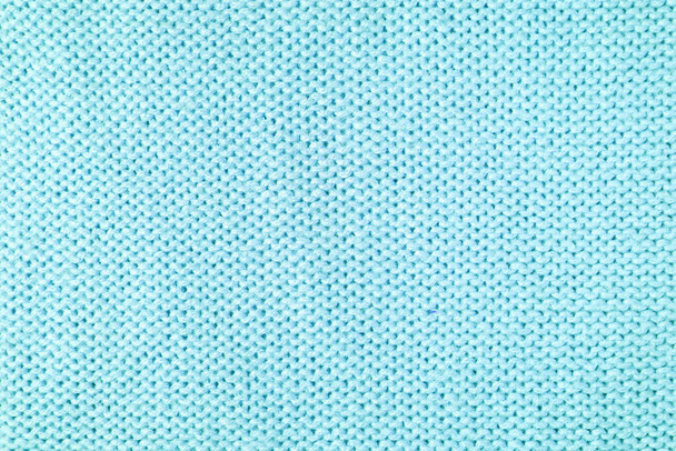 Primer plano del fondo de tejido de lana de punto hecho de hilo viscosa. Textura de punto de lana color turquesa pastel. Fondo abstracto de punto jersey. Fondo abstracto de tela, fondo de pantalla - Foto, Imagen