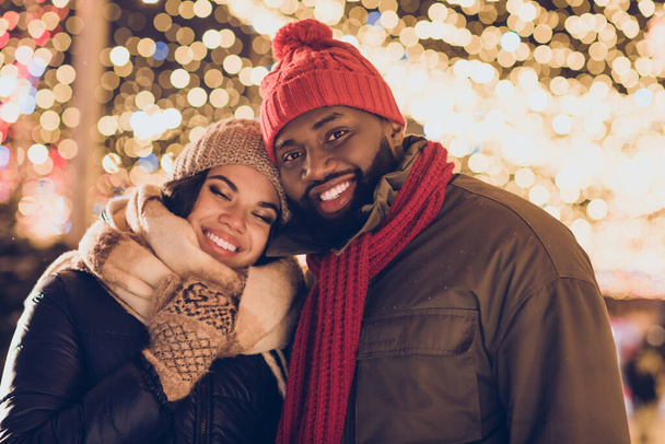 Photo of dreamy boyfriend girlfriend dressed winter season outfits embracing enjoying noel x-mas outdoors urban city street. - Foto, imagen
