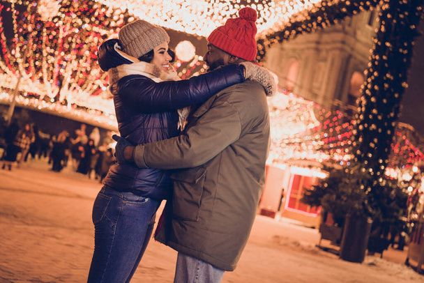 Photo of cheerful funny husband wife wear winter season clothes hugging celebrating xmas outside urban city street. - Foto, Imagem