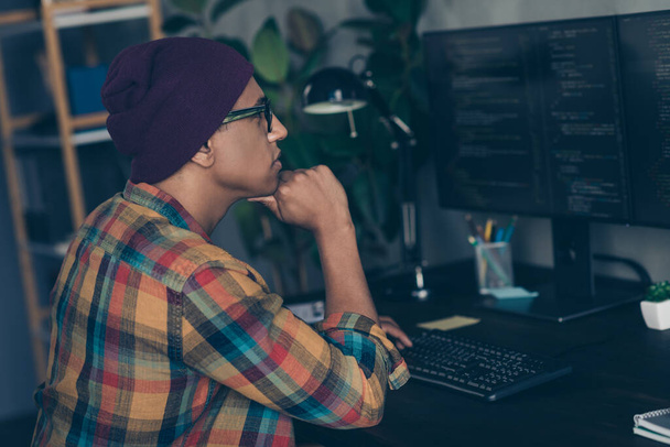 Photo of thoughtful cool businessman dressed hat glasses debugging problems modern device indoors workplace workstation loft. - Foto, afbeelding