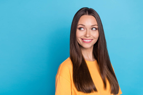 Portrait of lovely gorgeous adorable woman brown hairstyle dressed yellow t-shirt look empty space isolated on blue color background. - Foto, Bild