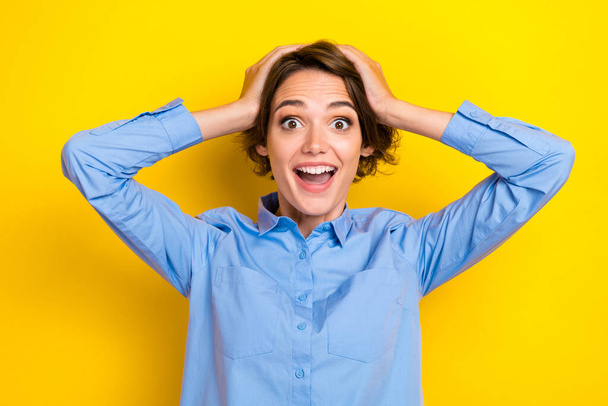 Closeup photo of young adorable gorgeous lady wear blue smart clothes hands hold head open mouth reaction big salary isolated on yellow color background. - Foto, immagini