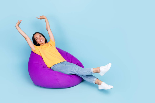 Photo of good mood nice girl bob hairdo wear yellow t-shirt lay stretching on purple bean bag chair isolated on blue color background. - Φωτογραφία, εικόνα
