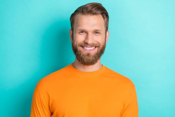 Photo portrait of attractive young guy toothy beaming smiling dressed stylish orange clothes isolated on aquamarine color background. - 写真・画像