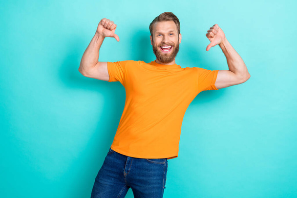 Photo of optimistic self confident man blond hairstyle dressed orange t-shirt directing at himself isolated on teal color background. - Foto, imagen