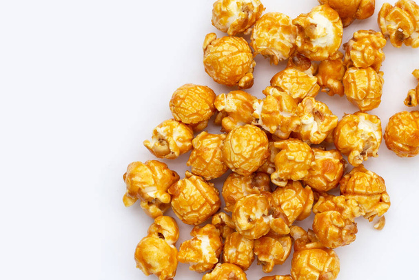 Honey caramel popcorn on white background. - Fotografie, Obrázek