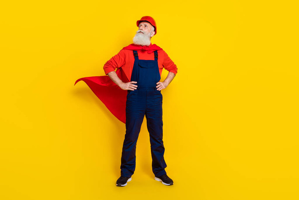 Full length photo of hero workman in red mantle costume ready reconstructing isolated shine color background. - Fotografie, Obrázek