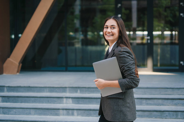 Portrait of professional young caucasian business woman going to work with laptop outdoors. Modern lifestyle concept. Smiling woman outdoor portrait. Beautiful - Φωτογραφία, εικόνα
