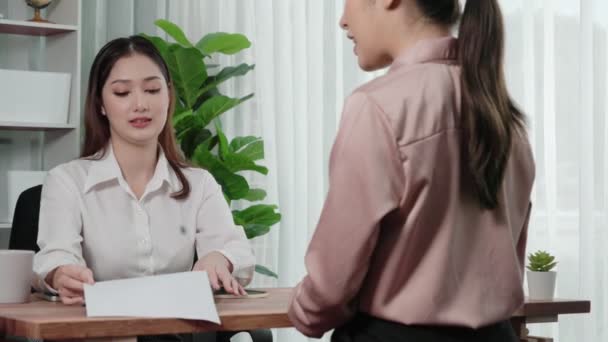 Young and enthusiastic candidate interview with professional HR manager in the office. Employer reviewing applicants resume in preparation for employment interview. - Footage, Video