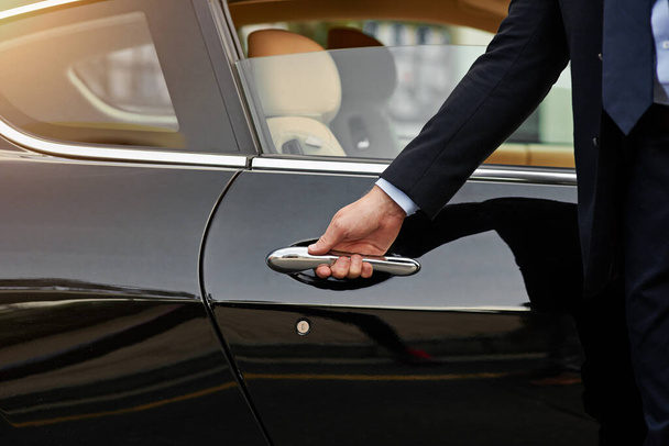 Your ride is here...an unrecognizable male chauffeur opening a car door - Foto, Imagem