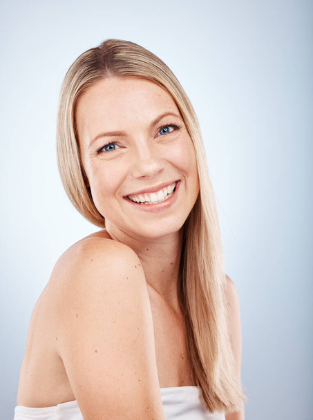 Hair care, beauty and portrait of a happy woman in a studio for wellness, long and healthy hair. Cosmetic, health and girl model from Australia with a blond hair style isolated by a gray background - Φωτογραφία, εικόνα