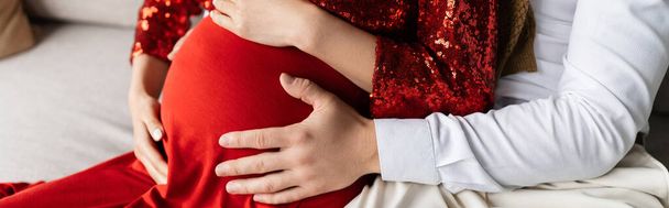 partial view of man embracing tummy of pregnant wife in elegant clothing, banner - Фото, изображение