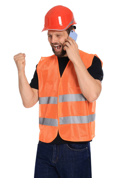Man in reflective uniform talking on smartphone against white background - Foto, immagini