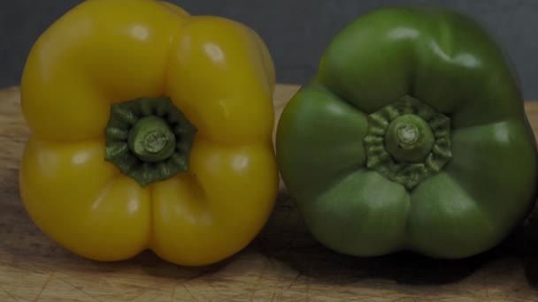Three sweet peppers. Three colorful bell peppers red yellow and green colors in a row. - Video