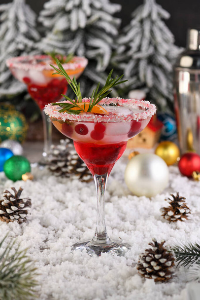 Christmas Cranberry margarita cocktail is mandarin and rosemary combined with cranberries and tequila. This cocktail is bursting with vibrant citrus and herb aromas, showcasing the best winter season fruits.Festive Christmas or New Year drink - Zdjęcie, obraz