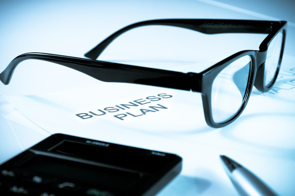 business plan words near glasses, pen and calculator, business concept - Photo, Image