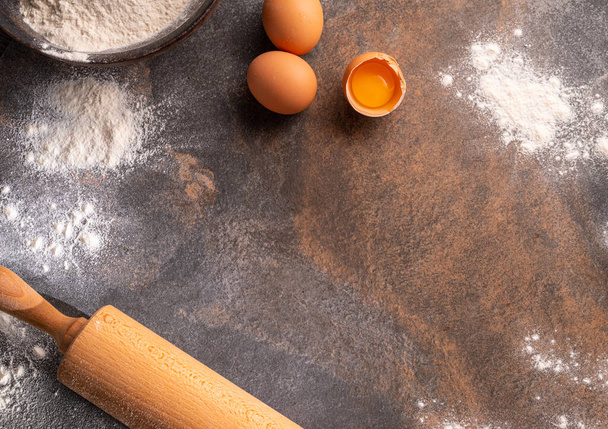 Preparation for dough cooking. Top view of board, rolling pin and flour. - Φωτογραφία, εικόνα
