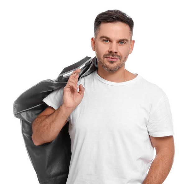 Man holding garment cover with clothes on white background. Dry-cleaning service - Photo, image