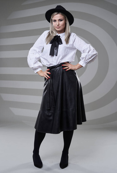 Business woman in black skirt and white shirt, full length studio portrait on gray background - Photo, Image